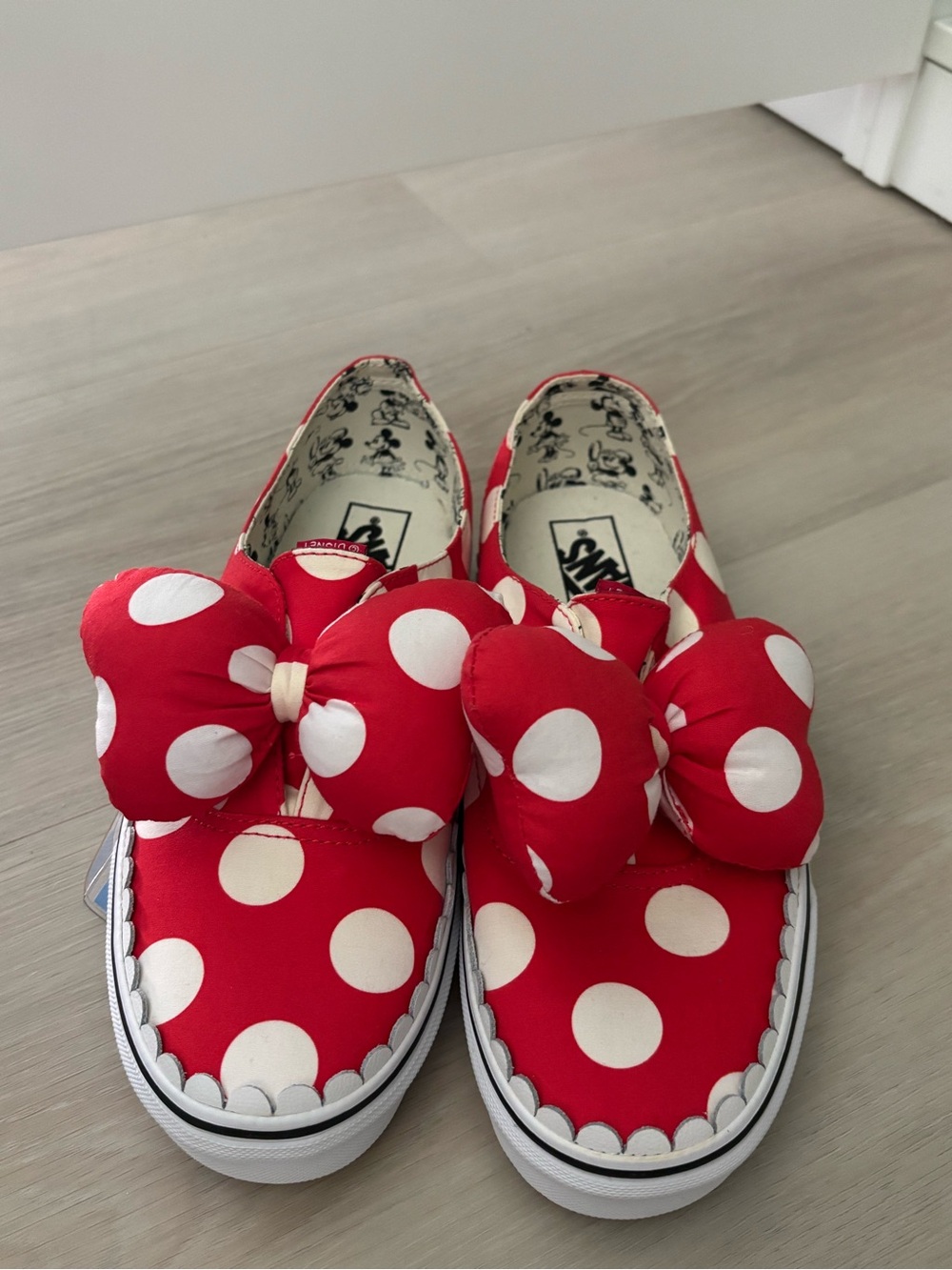 Vans women’s Disney Red Polka Dot Slip-On Sneakers with Bow